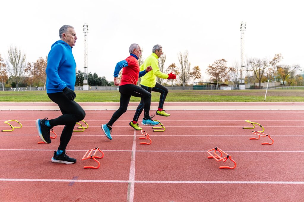 Active Senior Men Performing Agility Drills on Track